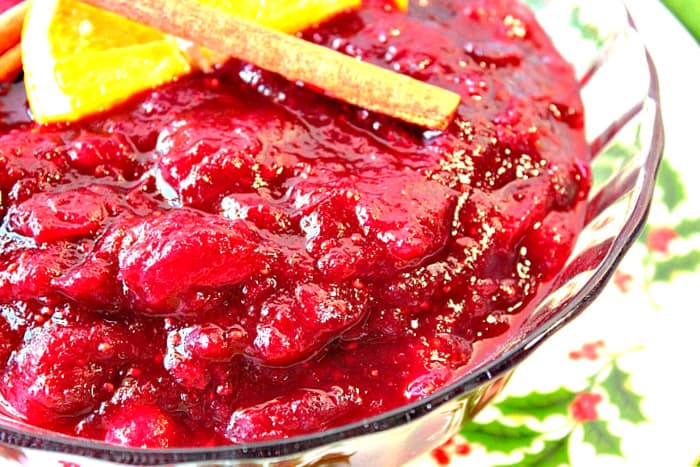 Super closeup horizontal photo of a dish of whole berry cranberry sauce.