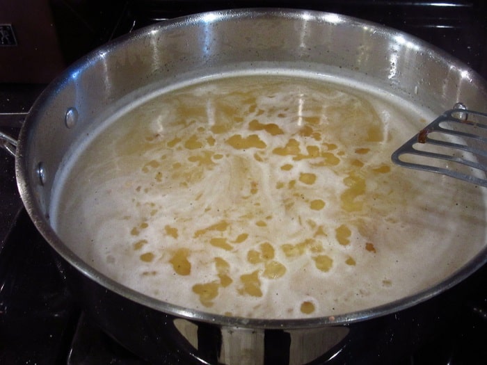 Simmering stock in a skillet.