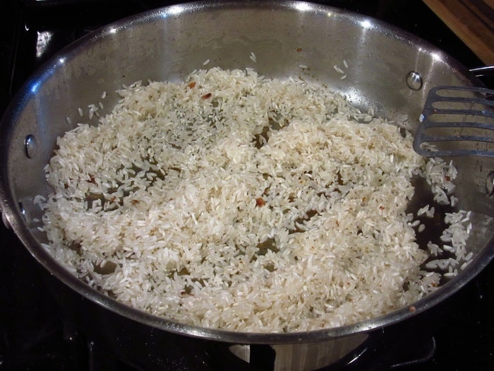 Sauteed rice in a skillet.