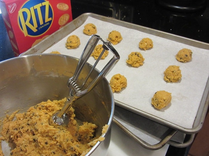 A cookie scoop in a bowl of Ritz Cookie Dough.