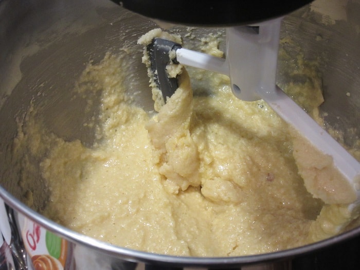 Cookie dough batter in a stand mixer bowl with the paddle attachment.