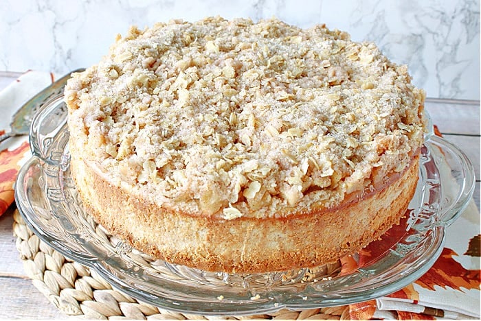 A Dutch Apple Cheesecake on a pretty glass plate.