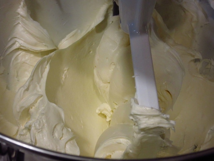 Whipped cream cheese in a stand mixer.