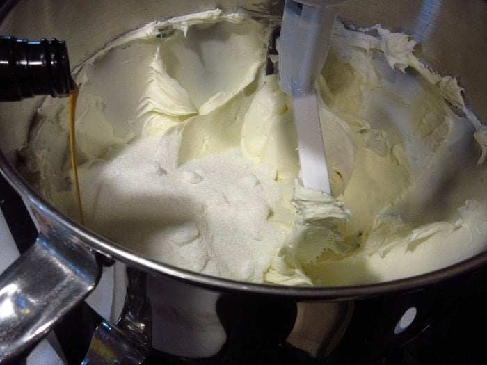 Vanilla extract being added to a stand mixer.