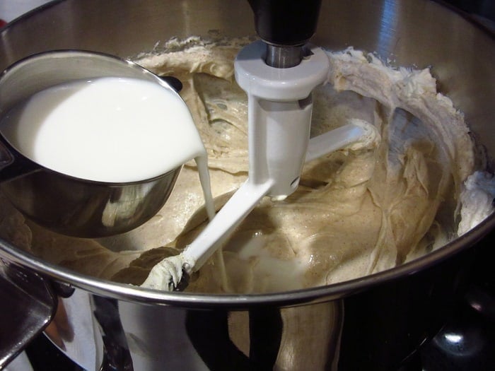 Milk being added to a cheesecake filling. 