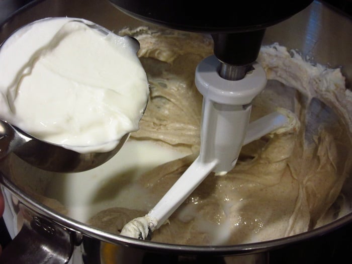 Greek yogurt being added to a cheesecake filling. 