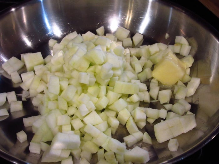 Chopped apples in a skillet with butter.