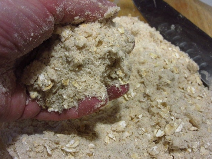 A hand holding asome streusel topping.