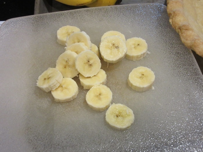 Sliced bananas on a cutting board.