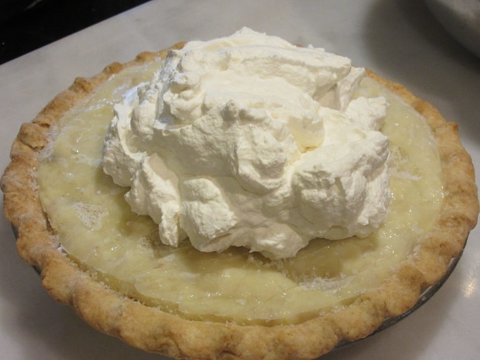 Whipped cream piled on top of a frozen Banana Cream Pie.
