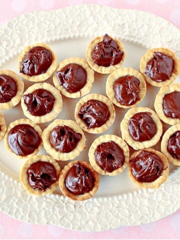 A pretty white platter filled with Nutella Cookie Cups.