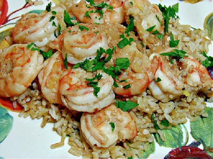 Skinny Shrimp Scampi on a colorful plate with parsley and brown rice.