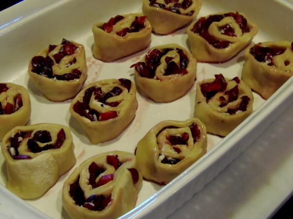 Unbaked Cherry Sweet rolls in a casserole dish.