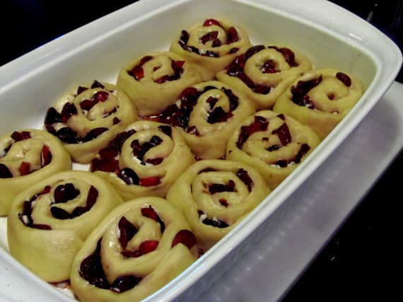 Risen Cherry Sweet Rolls in a baking dish before baking.