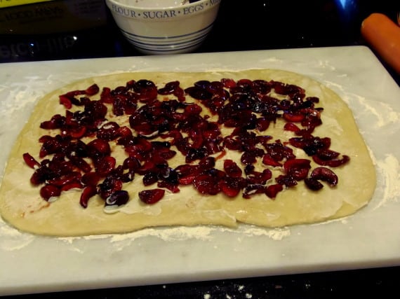 Cherries spread over dough.