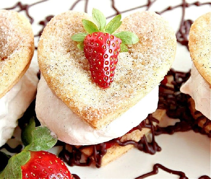 A super closeup of a Deconstructed Strawberry Pie with a cinnamon-sugar crust-pie heart along with fresh strawberries and chocolate ganache.