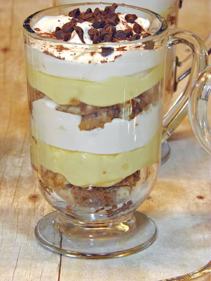 A vertical closeup of a Skinny Tiramisu Parfait in a glass coffee mug.