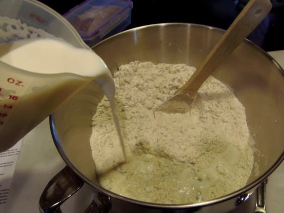 Warm milk being poured into dry ingredients.