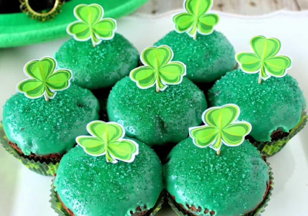 A super close image of Chocolate Mint Brownie Cupcakes with green icing and green sanding sugar.