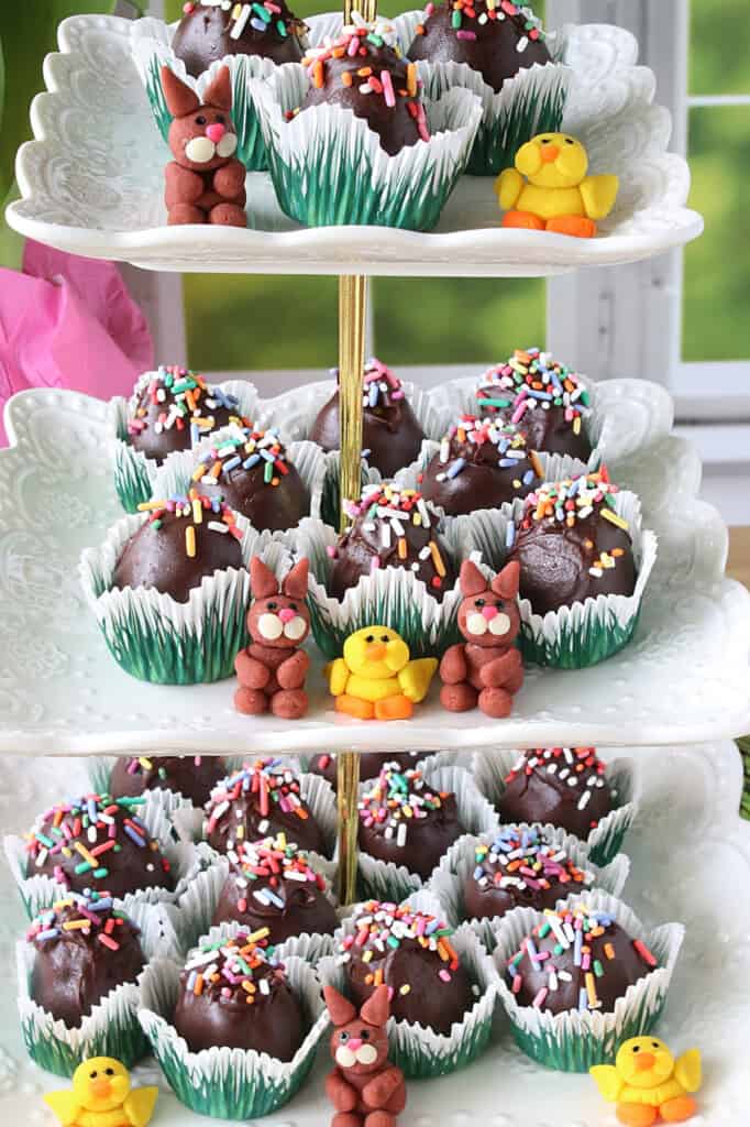 A tiered stand filled with Chocolate Peanut Butter Eggs with sprinkles.