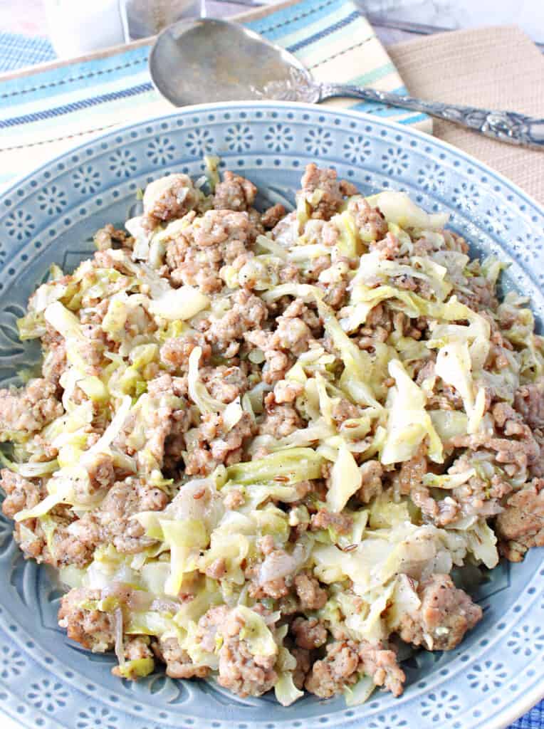 A recipe for Ground Pork and Cabbage Skillet in a pretty blue bowl.