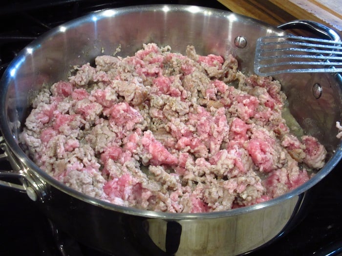 Browning ground pork in a skillet.
