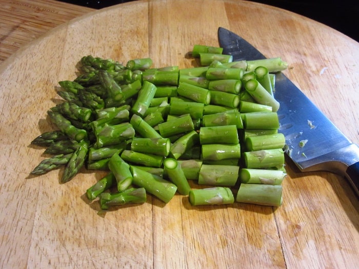 Chopped asparagus on a cutting board.