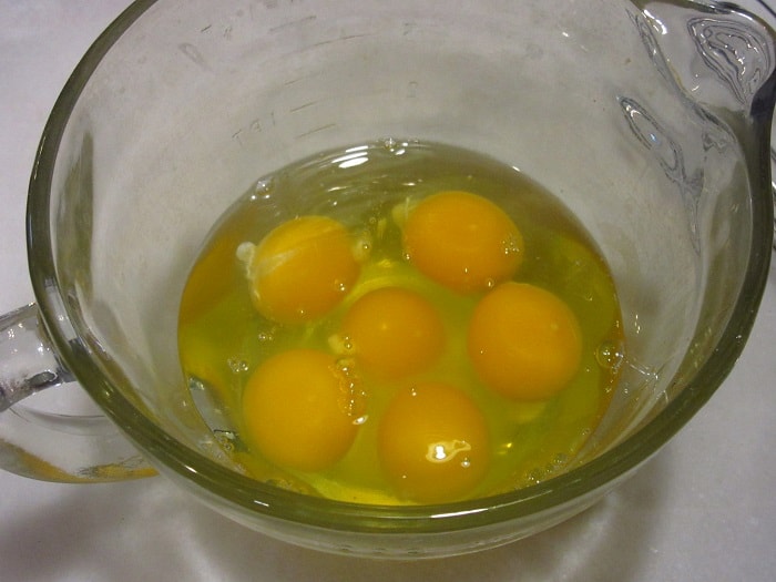Eggs in a glass measuring bowl.