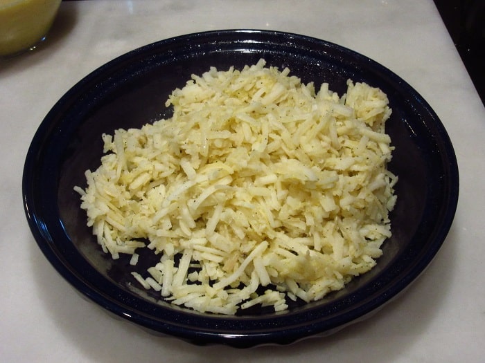 Frozen and thawed hash browns in a pie tin.