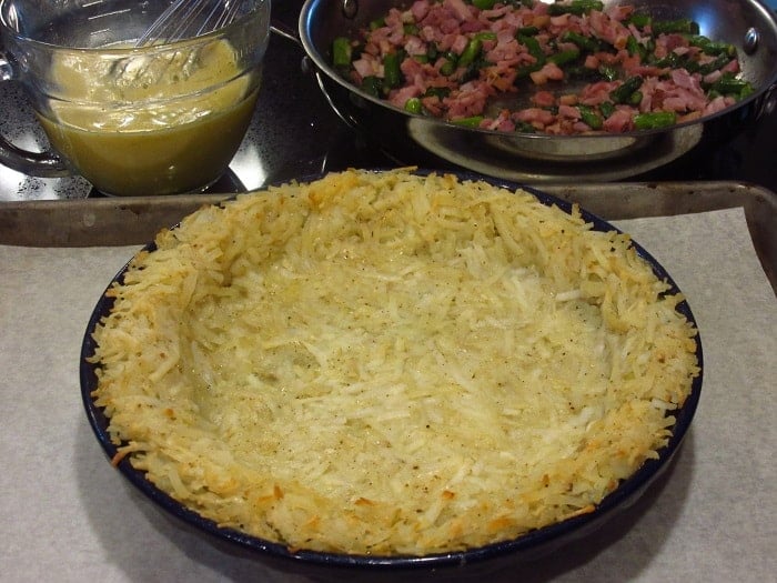 A partially baked hash brown crust for a quiche.