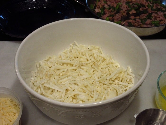 A bowl filled with frozen hash brown potatoes.