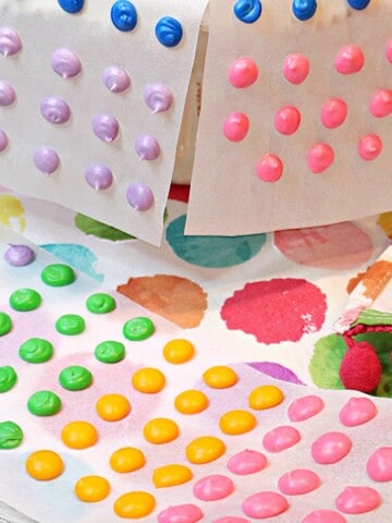 Colorful Homemade Candy Dots of strips of white paper.