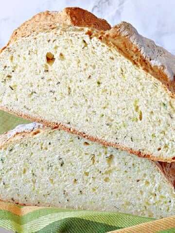 Two halves of Irish Soda Bread with Dill stacked on top of each other.