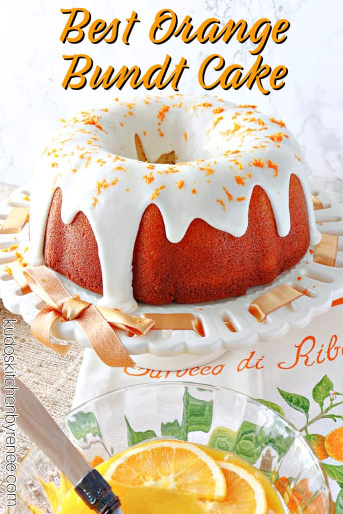 A vertical closeup photo of an Orange Bundt Cake on a white cake stand with an orange ribbon along with a title text overlay graphic.