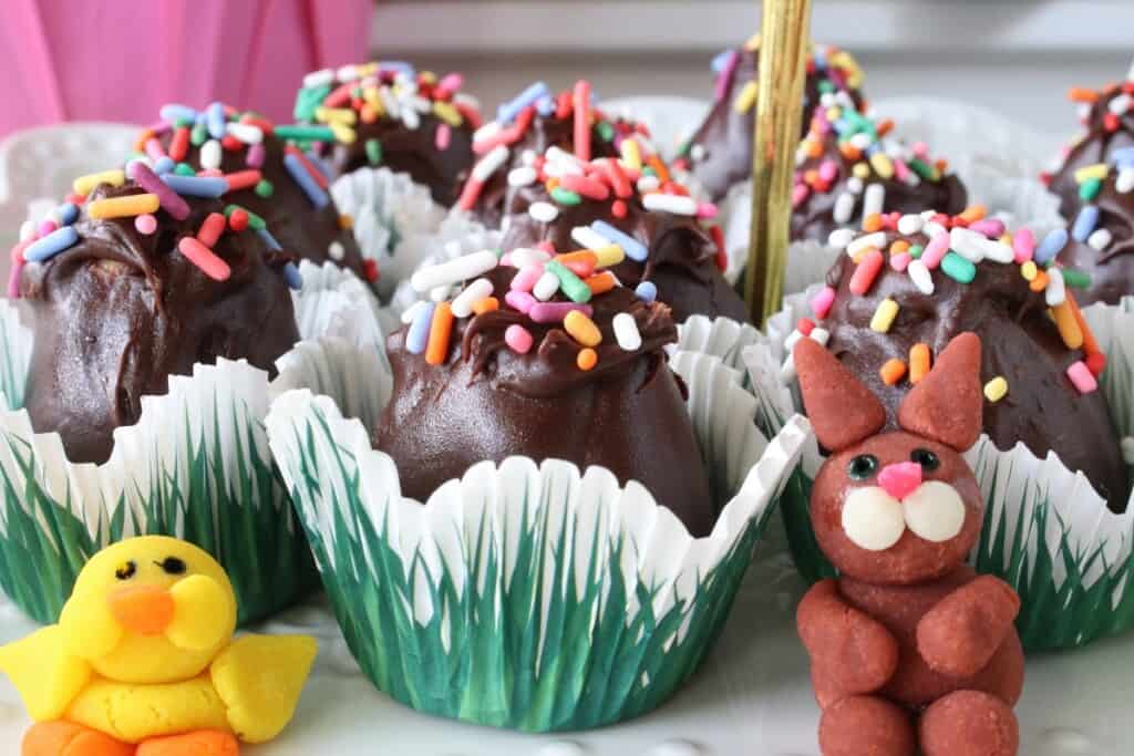 A Chocolate Peanut Butter Egg in a cute paper cup with a bunny and chick.