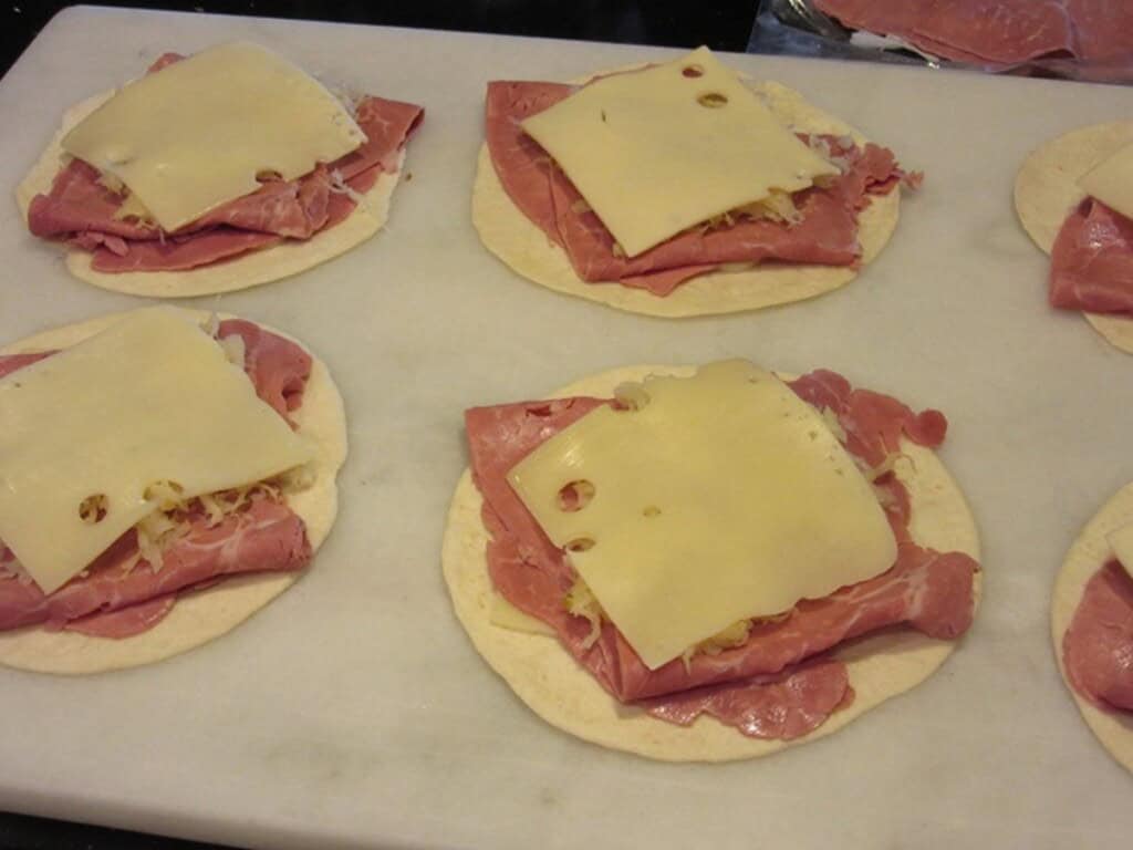 Corned beef and sliced Swiss cheese on top of flour tortillas to make quesadillas.