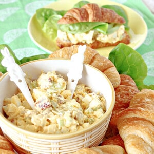 A bowl of Bacon Egg Salad in the foreground and a sandwich in the background.