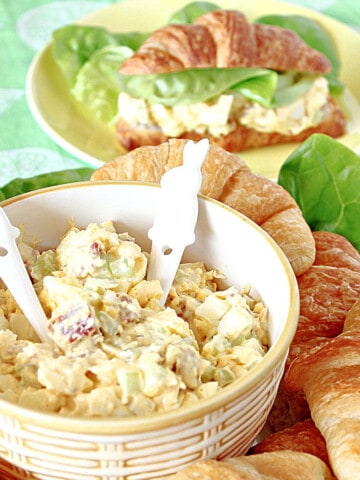 A bowl of Bacon Egg Salad in the foreground and a sandwich in the background.