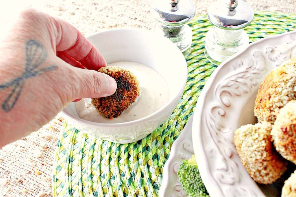 A horizontal photo of a hand dipping a Broccoli Cauliflower Vegetable Tot into ranch dressing.