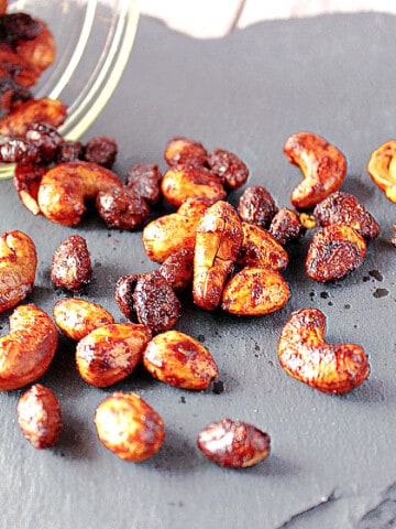 Brown Butter Roasted Nuts on a black slate tile.