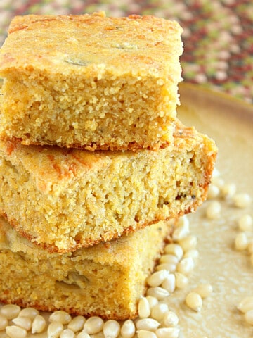 Three pieces of stacked Buttermilk Green Chili Cornbread on a plate.