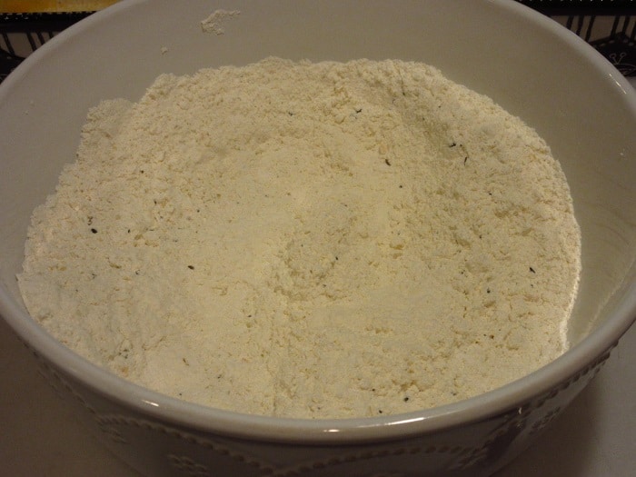 A mix of flour and seasoning in a white bowl.