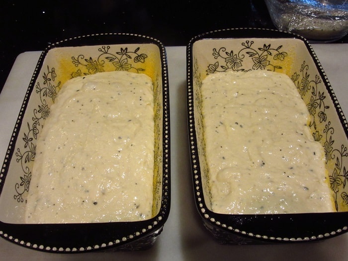 Two loaf pans with Everything English Muffin Bread dough before baking.