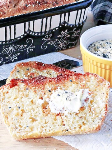 Two slices of toasted Everything English Muffin Bread along with some butter.