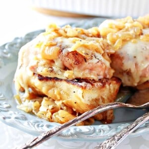 A French Onion Chicken Thigh on top of French bread and caramelized onions after baking.