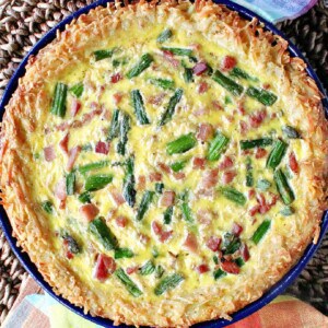 An overhead photo of a Ham and Asparagus Quiche with a Hash Brown Crust.
