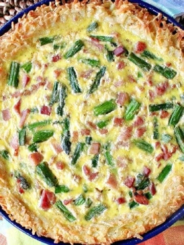 An overhead photo of a Ham and Asparagus Quiche with a Hash Brown Crust.