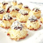 A light bright image of Almond Joy Coconut Macaroons on a white platter.