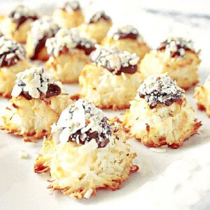 A light bright image of Almond Joy Coconut Macaroons on a white platter.