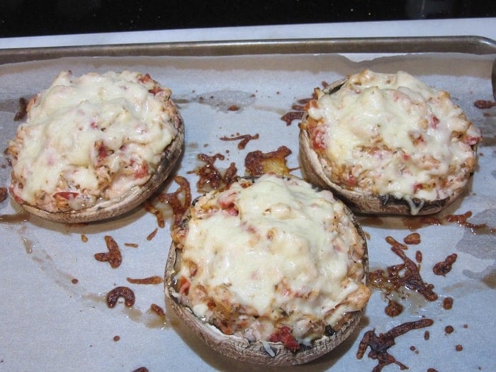 Baked Chicken Parmesan Stuffed Portobello Mushrooms on a baking sheet.